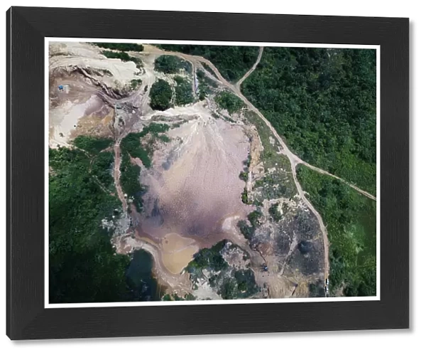 An aerial view shows the location of an illegal gold mine as its machines are destroyed