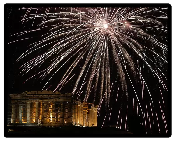 Fireworks explode over the ancient Parthenon temple atop the Acropolis hill during New