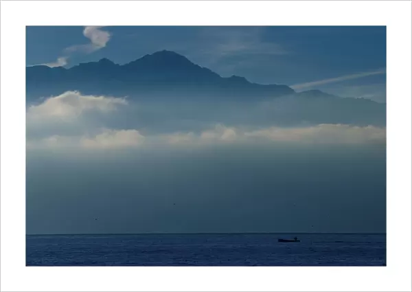 A fisherman sails to his net early morning on Lake Leman in Lausanne