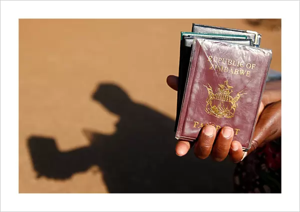 A street vendor offers passport covers for sale outside a Home Affairs Department office
