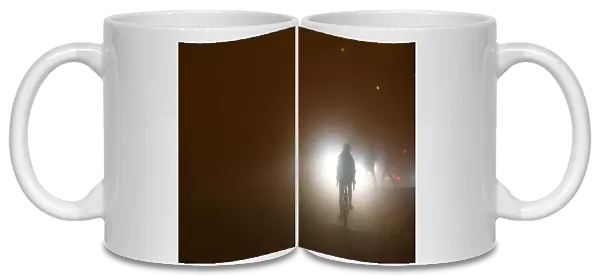 A person cycles through heavy fog in Dublin