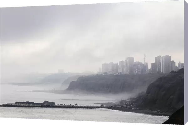 A coastal neighborhood in the district of Miraflores is covered by fog in Lima