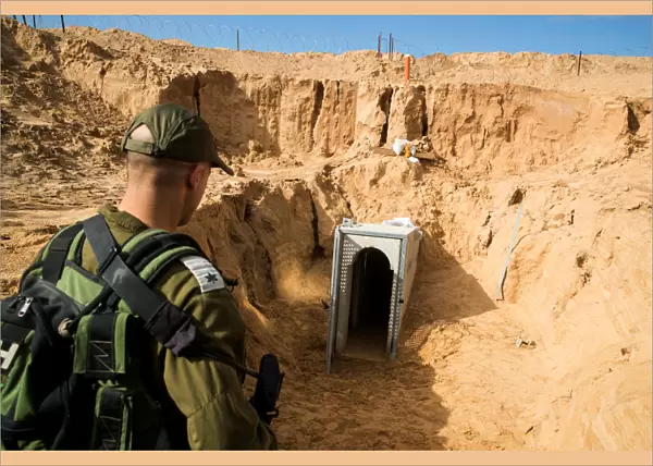 An Israeli soldier stands next to an entrance to what the Israeli military say is a