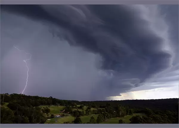 Lightning can be seen as a large storm front crosses over the Sydney suburb of Wakehurst