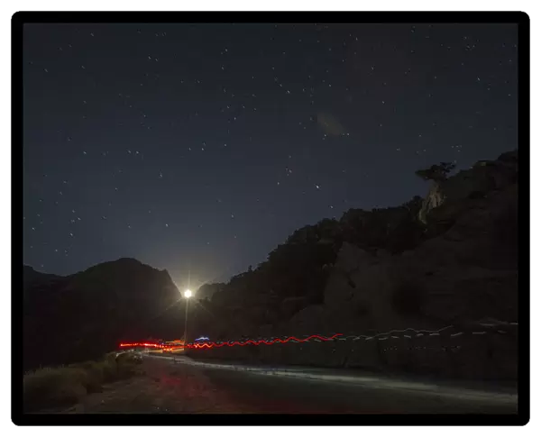 A trail of headlamps is seen as runners make their way to the finish line in the Badwater