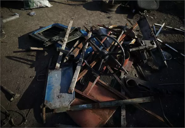 Pieces of a truck are seen on the ground in a scrapyard in Port-au-Prince