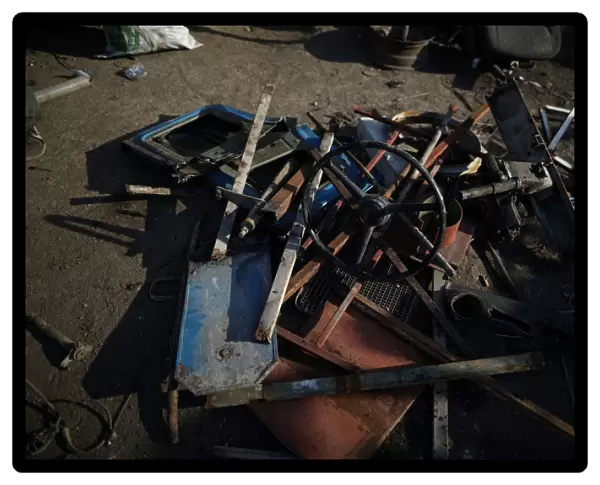 Pieces of a truck are seen on the ground in a scrapyard in Port-au-Prince