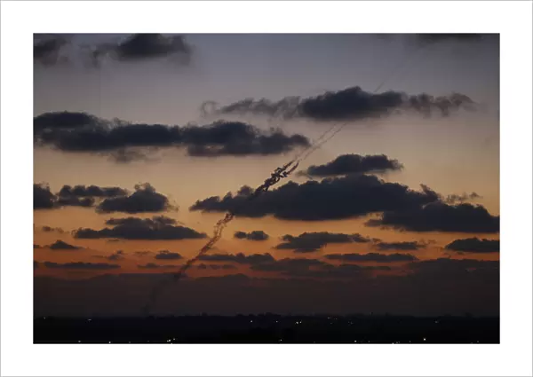 A smoke trail is seen as a rocket is launched from the northern Gaza Strip towards Israel