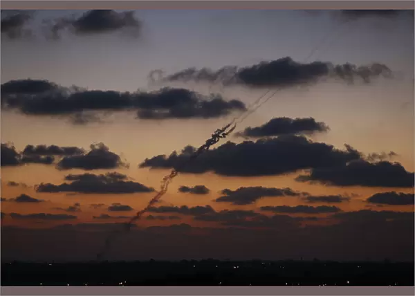 A smoke trail is seen as a rocket is launched from the northern Gaza Strip towards Israel