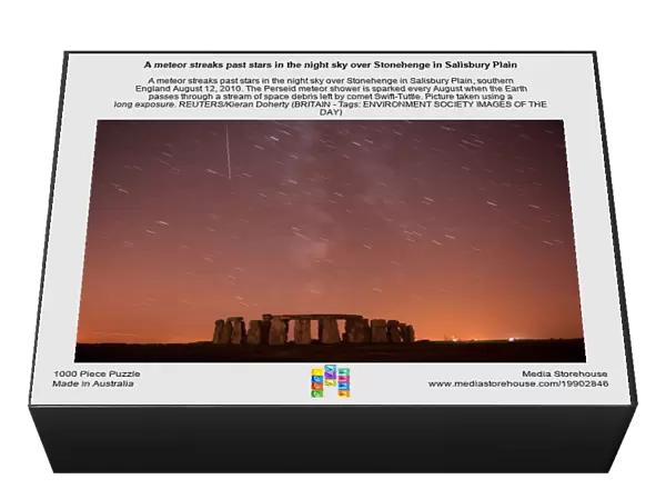 A meteor streaks past stars in the night sky over Stonehenge in Salisbury Plain