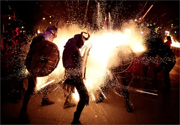 Revellers dressed as devils walk among fireworks during Correfocs in Palma de Mallorca