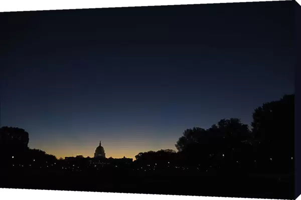 Sun rises over the U. S. Capitol dome in Washington