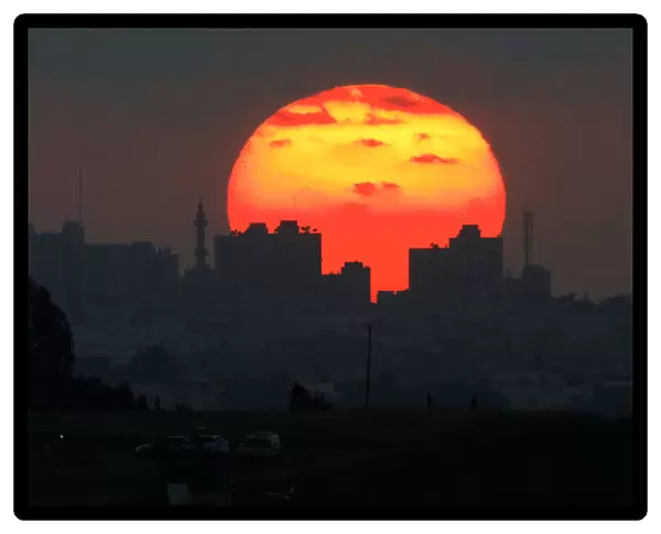 The sun sets over the Gaza Strip, as seen from the Israeli side of the border