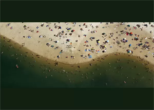 An aerial view shows people cooling off at a beach on the shores of the Silbersee lake