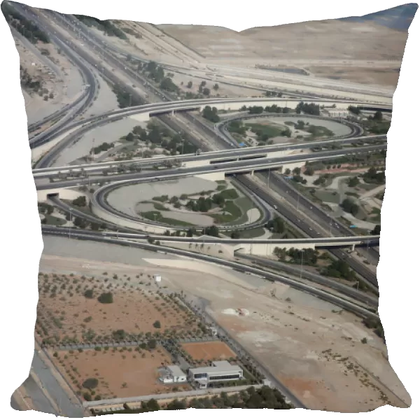 An aerial view of bridges and roads of Abu Dhabi is pictured through the window of an