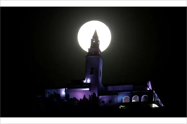 A supermoon is pictured next to the Monserrate church in Bogota