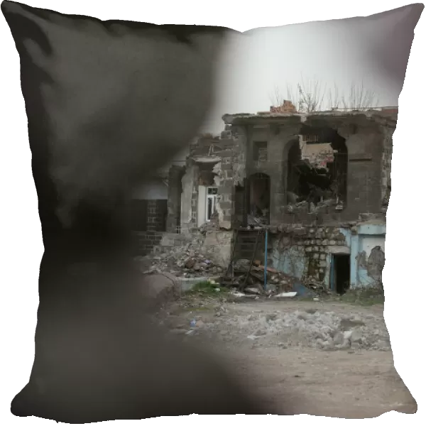 A partial view from behind a banner of Sur, a historical district ravaged by urban