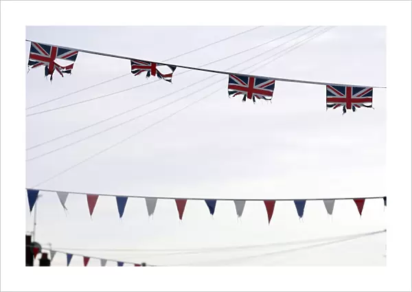 Union flags and coloured bunting hang above a street in South Belfast