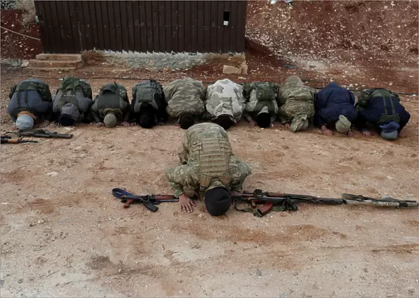 Turkey-backed Free Syrian Army fighters pray at a training camp in Azaz