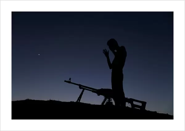 A Free Syrian Army fighter prays after eating his iftar (breaking fast