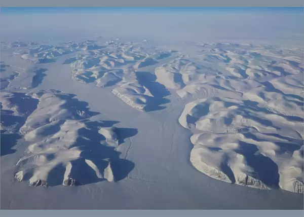 Glaciers wind their way through mountains on the way to the coast above eastern Greenland