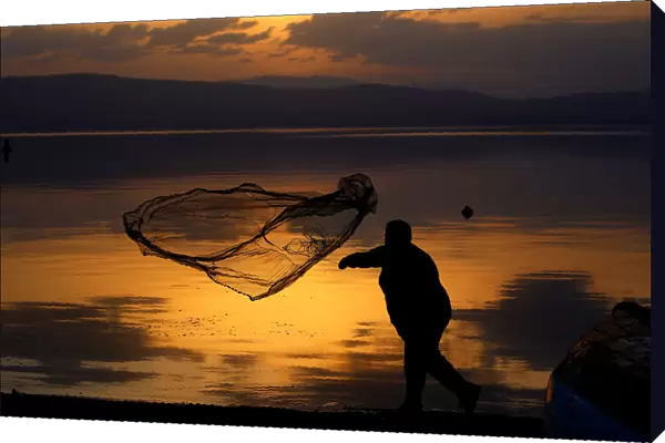 A fisherman uses his net at Lake Ohrid in Ohrid