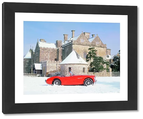 Austin Healey 100 in snow in front of Palace House