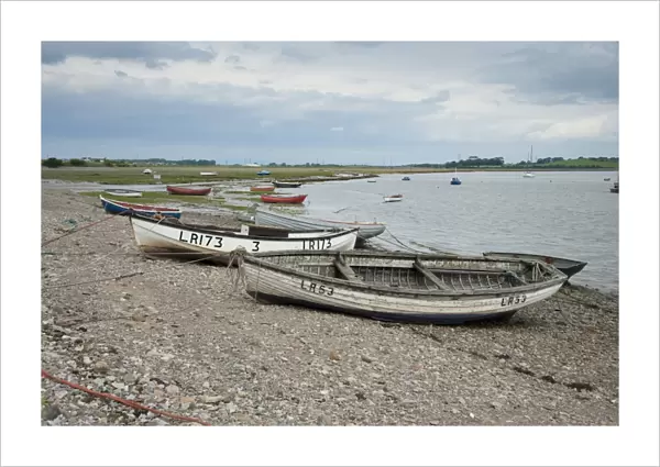 View of boats on shoreline at coastal village, only community on U. K. mainland dependent upon tidal access