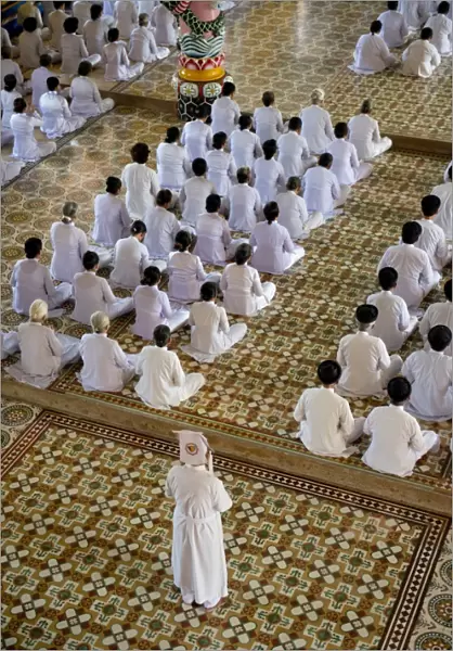 Caodaist disciples sitting during ceremony, Cao Dai temple, Tay Ninh Holy See, Tay Ninh, Tay Ninh Province, Vietnam