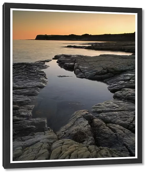 View of rockpool on beach at sunset, Hobarrow Bay, Isle of Purbeck, Dorset, England, july