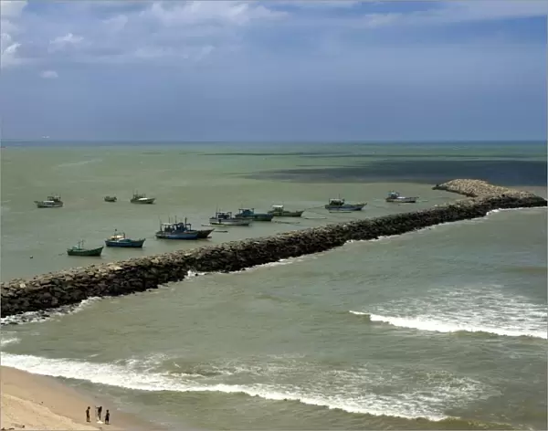 View of breakwater with moored fishing boats, confluence of Indian Ocean, Arabian Sea and Bay of Bengal
