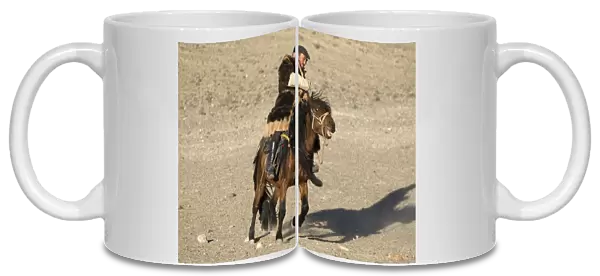 Kazakh nomad on horseback, riding on steppe, Altai Mountains, Bayan-Ulgii, Western Mongolia, october