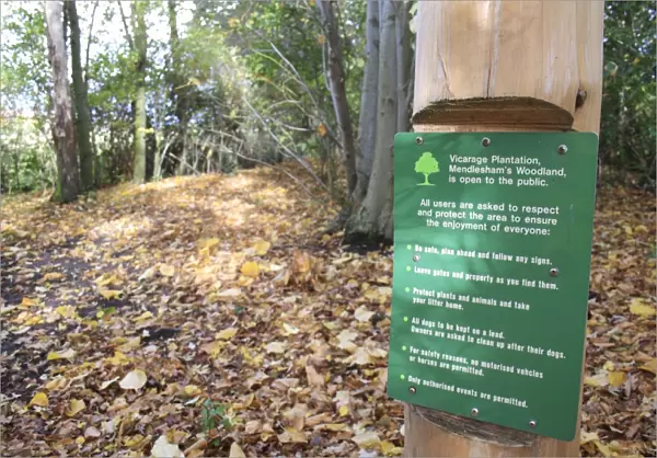 Notice with rules on post in woodland, Vicarage Plantation, Mendlesham, Suffolk, England, november