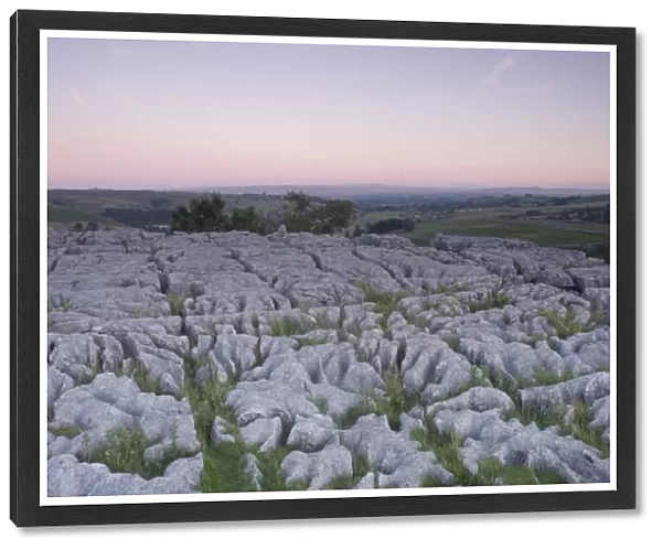 View of limestone pavement at sunset, above Malham Cove, Malhamdale, Yorkshire Dales N. P