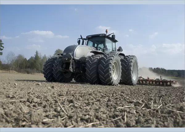 Valtra tractor with Vaderstad NZA-800 and Vaderstad RS-820 harrows and rollers, cultivating arable field, Sweden, april