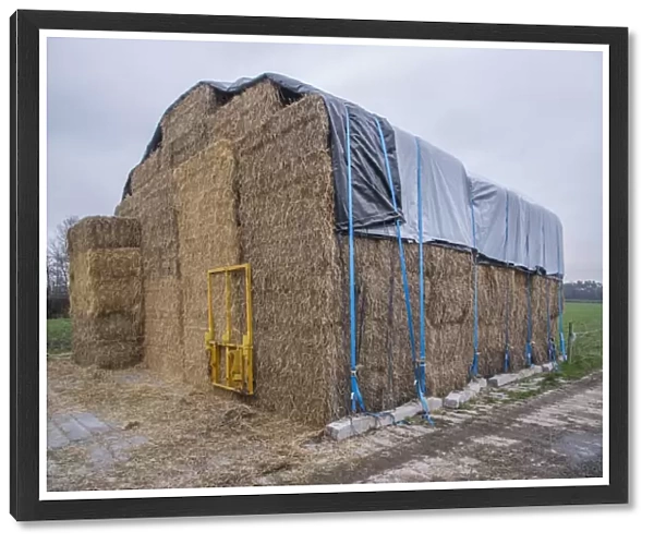 Covered big bale straw stack, Cheshire, England, January