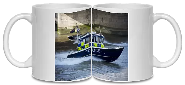 Police patrol boat patrolling city river, London Bridge, River Thames, London, England, april