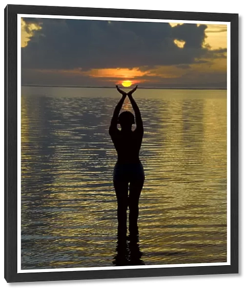 Indonesia, Bali. Woman silhouetted at sunrise on Sanur Beach. Credit as: Jones-Shimlock