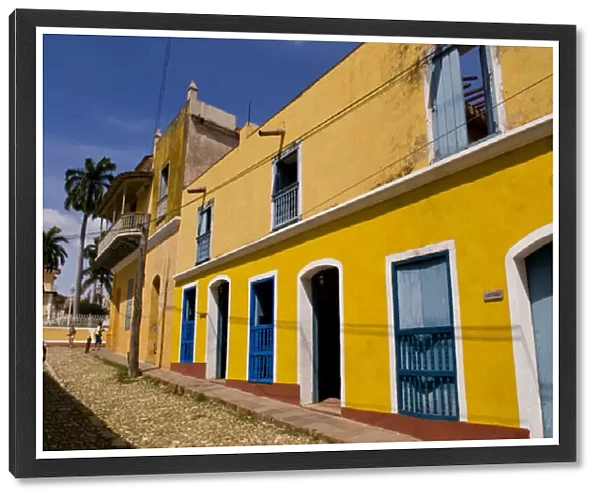 Old yellow building in colonial town of Trinidad Cuba
