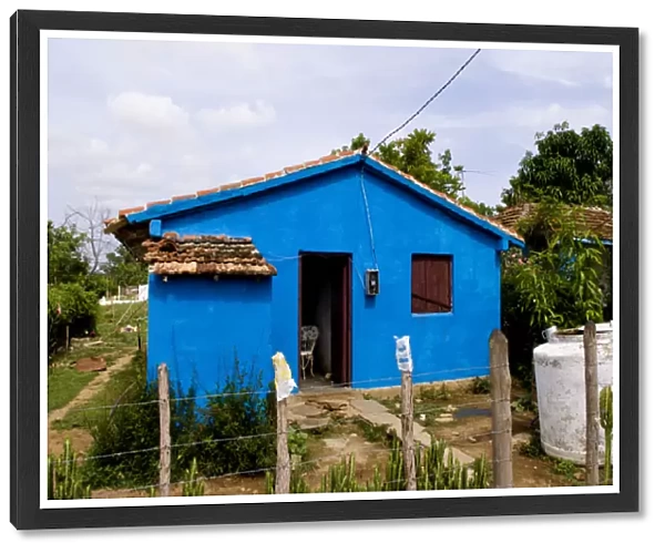 Local house painted blue in small village of Manaca Iznaca Estate home of the Plantation