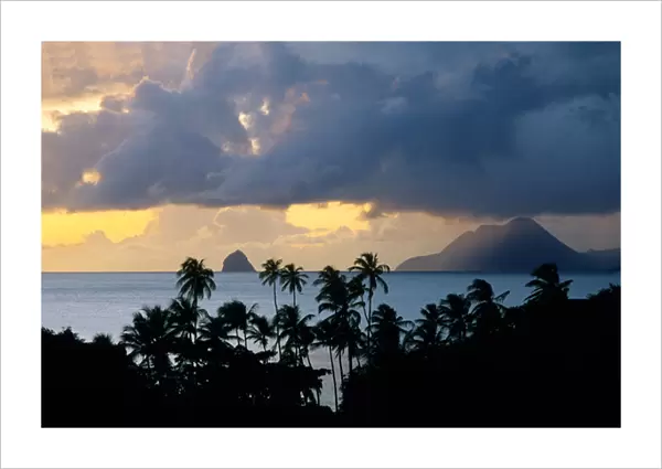 The sun sets behind Diamond Rock viewed from the island of Martinique in the Caribbean