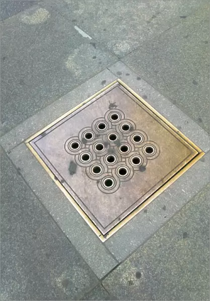 Decorated sewer cover in Prague Castle, Czech Republic