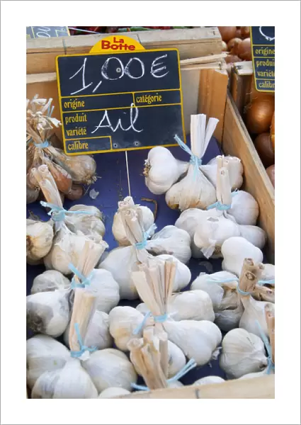 Bunches of garlic, ail, 1 euro for three, for sale at a market stall at the street