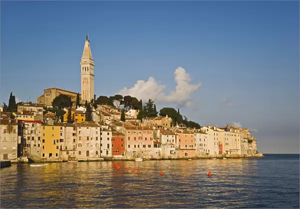 Rovigno skyline and Cathedral of St. Euphemia reflected on Adriatic Sea at sunrise
