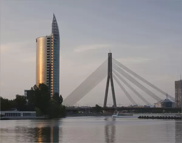 Latvia, Riga, Vansu Bridge, Swedbank building, and Daugava River, dusk