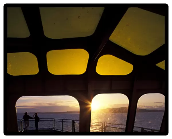 USA, Washington State, Seattle. Sunset on Washington State Ferry sailing across Elliot