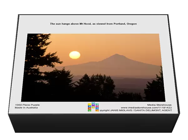 The sun hangs above Mt Hood, as viewed from Portland, Oregon