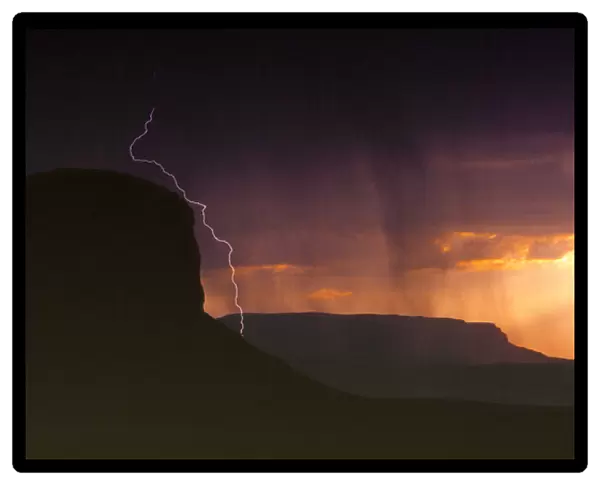 USA, Utah, Monument Valley. An afternoon lightning and thunderstorm darkens the sky