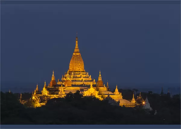 Myabnmar, Bagan. A giant stupa is lit at night on the plains of Bagan