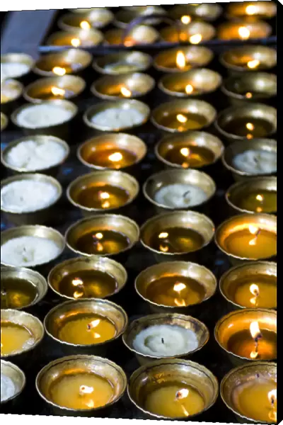 Candles burning in the Chimi Lhakhang moastery, Bhutan
